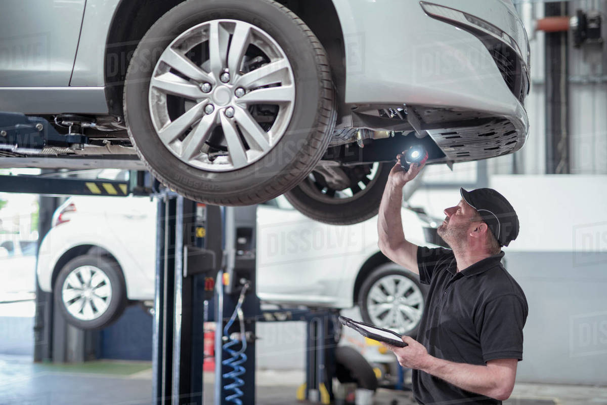 Engineer checking car on ramp in car service centre Royalty-free stock photo