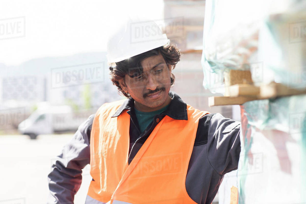 Male engineer on construction site inspecting construction materials Royalty-free stock photo