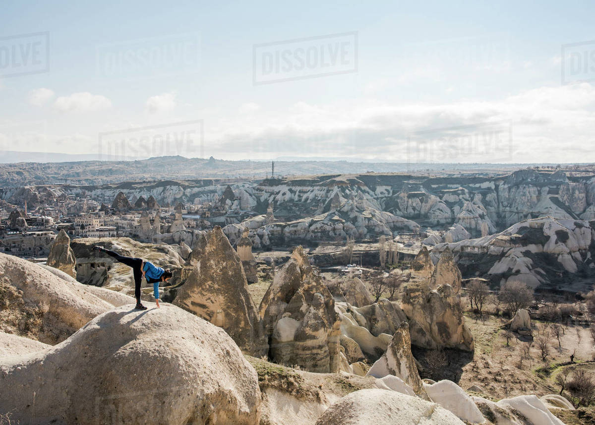 Woman practising yoga on top of rock, Göreme, Cappadocia, Nevsehir, Turkey Royalty-free stock photo