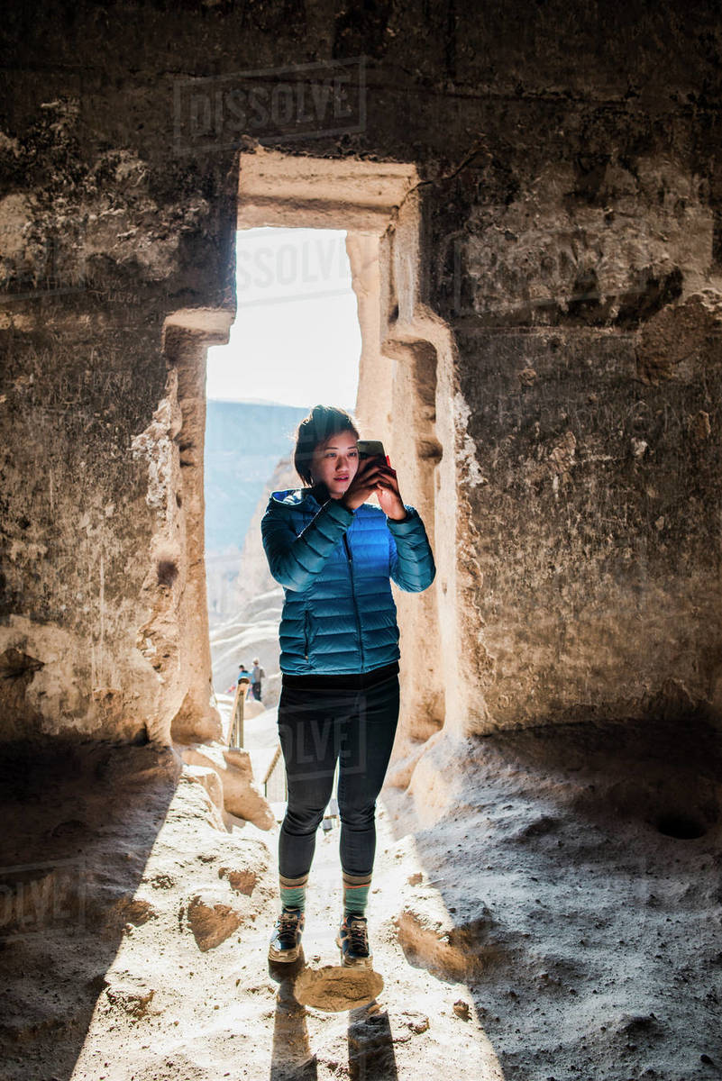 Woman taking photograph in Selime Monastery, Göreme, Cappadocia, Nevsehir, Turkey Royalty-free stock photo