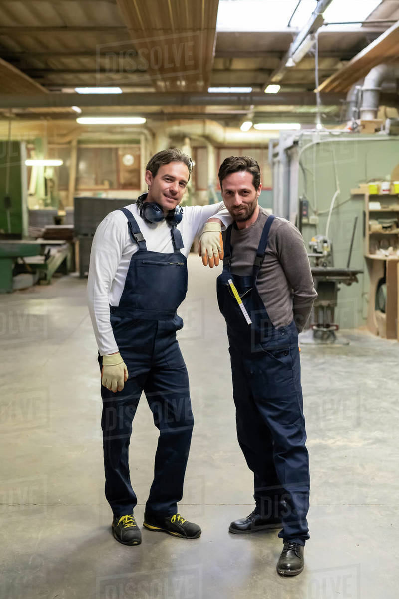 Worker resting arm on colleague's shoulder in factory Royalty-free stock photo