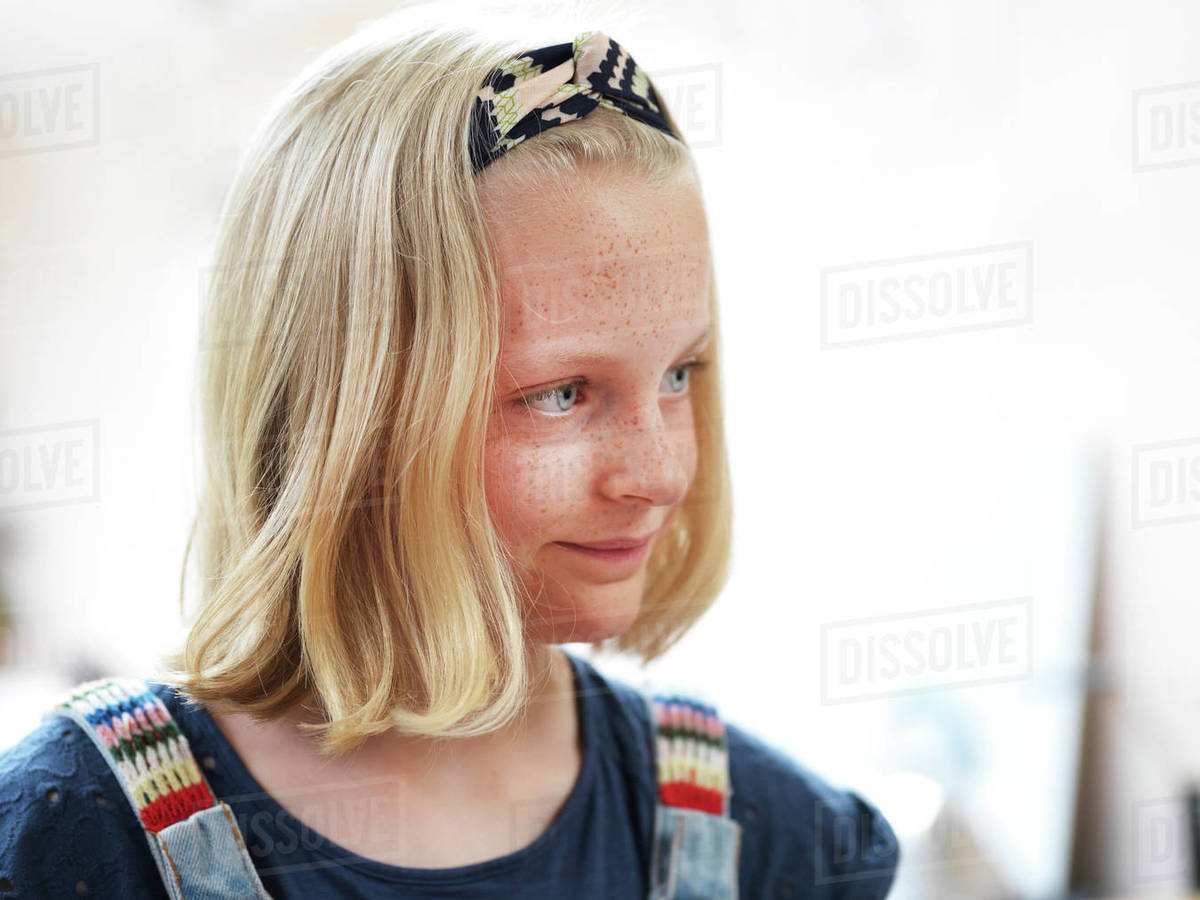 Girl with freckles and blond bobbed hair looking away, head and shoulder portrait Royalty-free stock photo