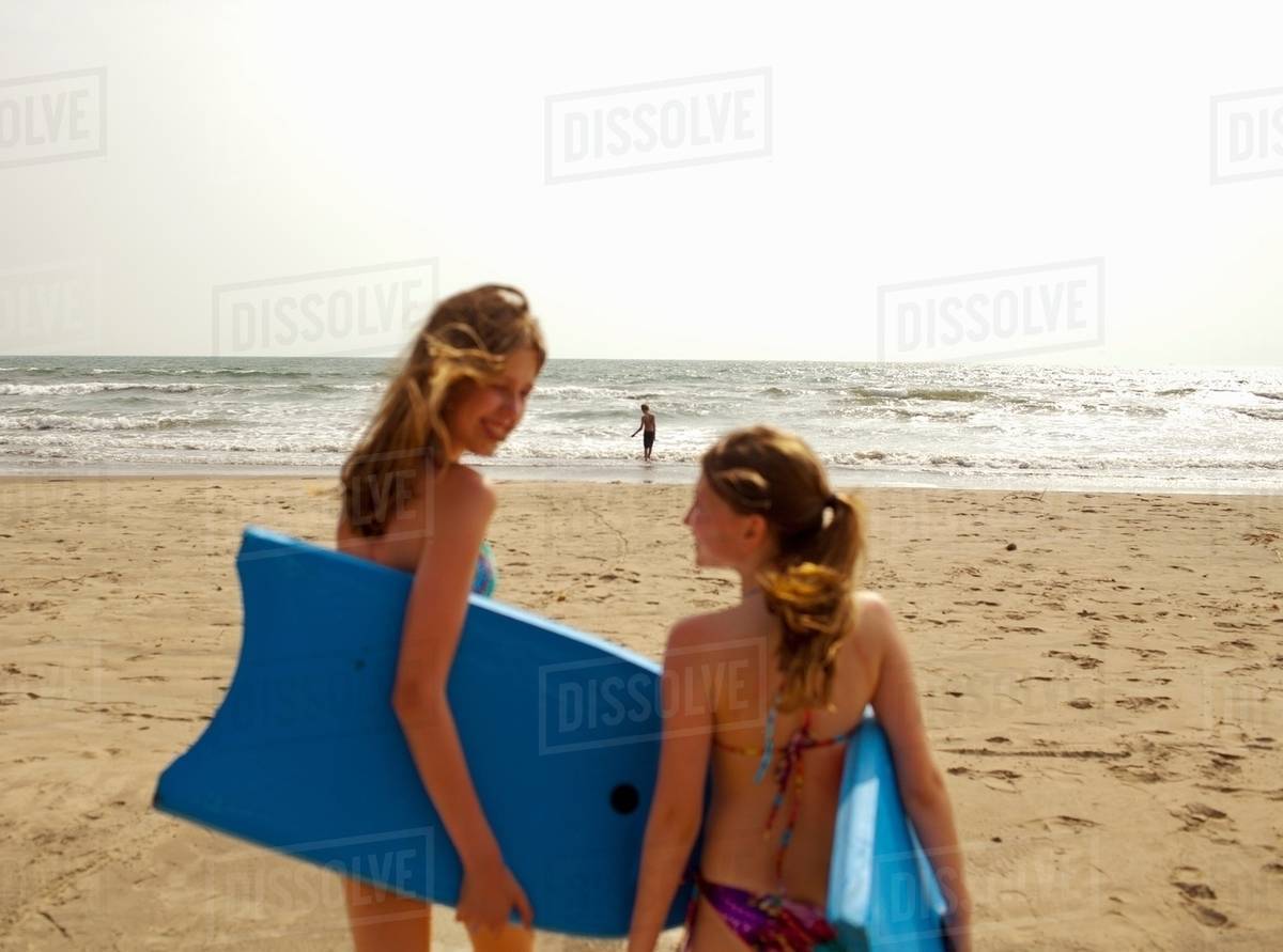 S Carrying Boogie Boards On Beach Stock Photo Dissolve S Carrying Boogie Boards On Beach