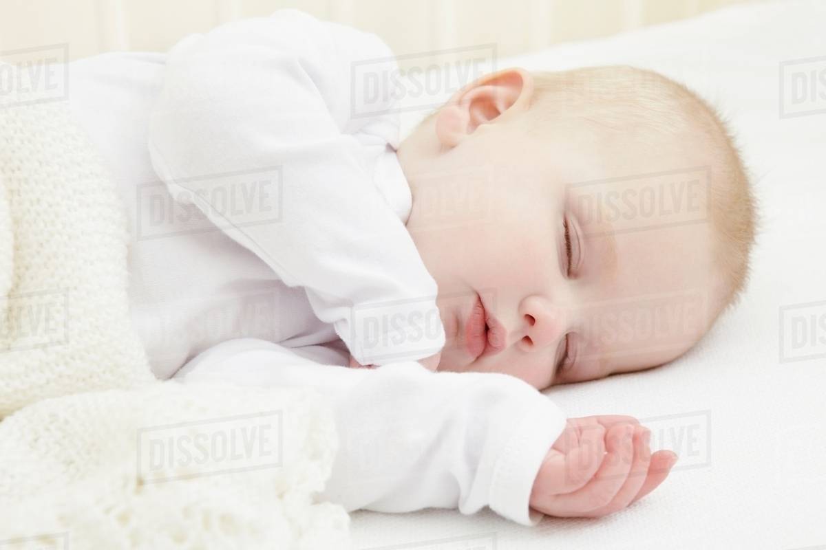 Baby girl sleeping in crib Stock Photo Dissolve