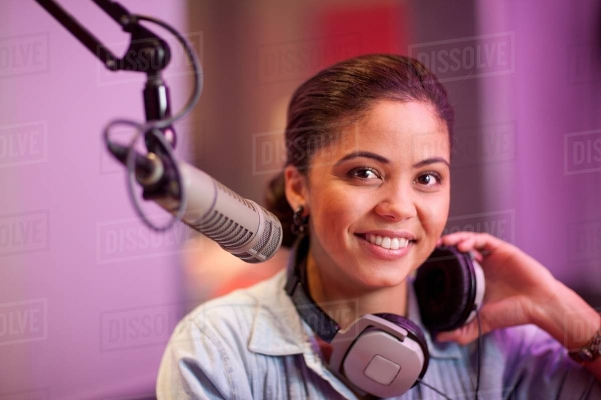 Young woman broadcasting in recording studio, portrait Stock Photo