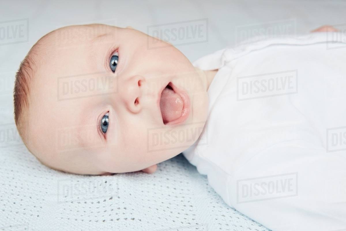 Baby sticking out tongue Stock Photo Dissolve