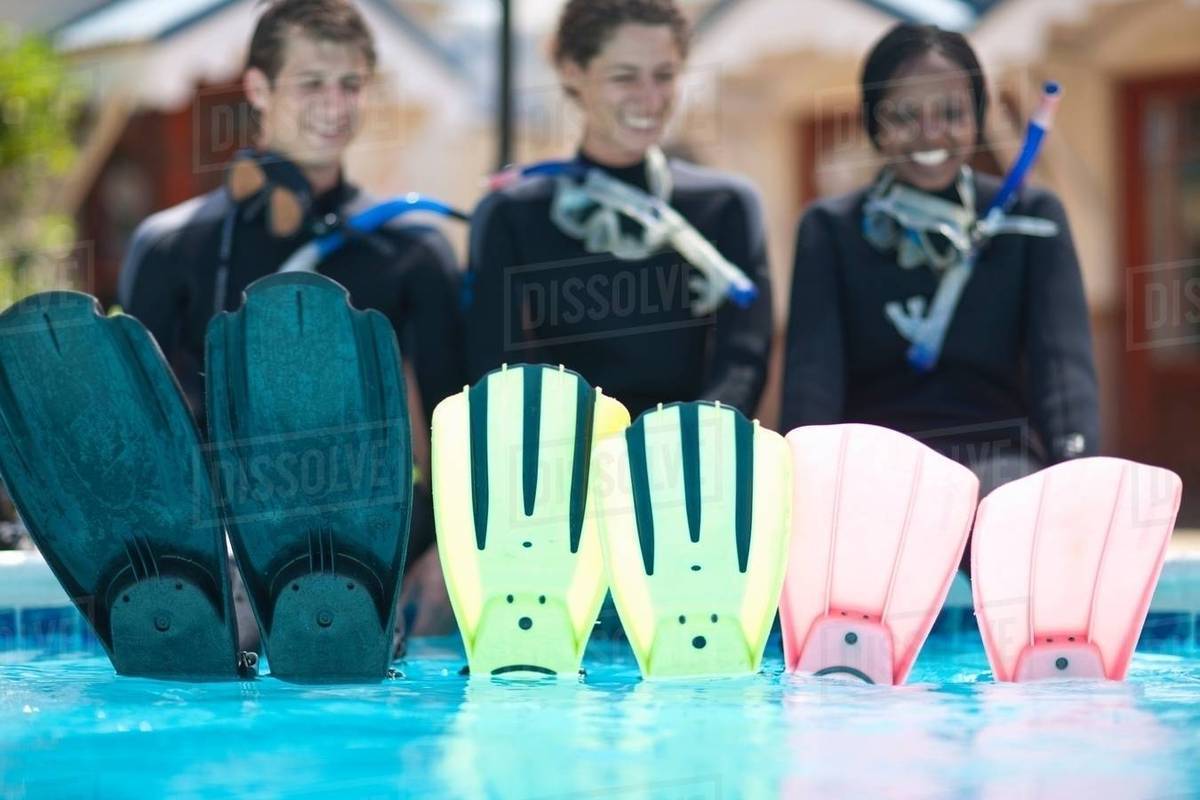 Portrait three young adult scuba divers and their flippers Stock