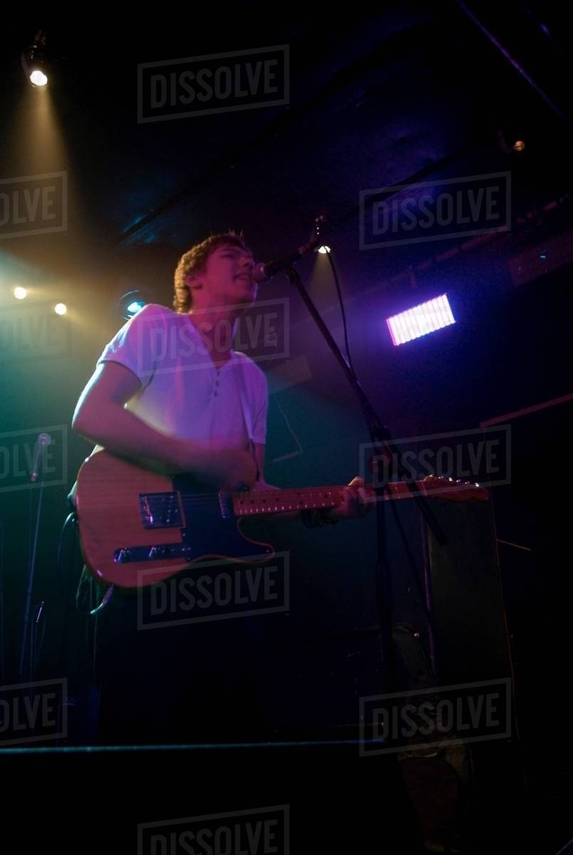 Lead vocalist with guitar Stock Photo Dissolve