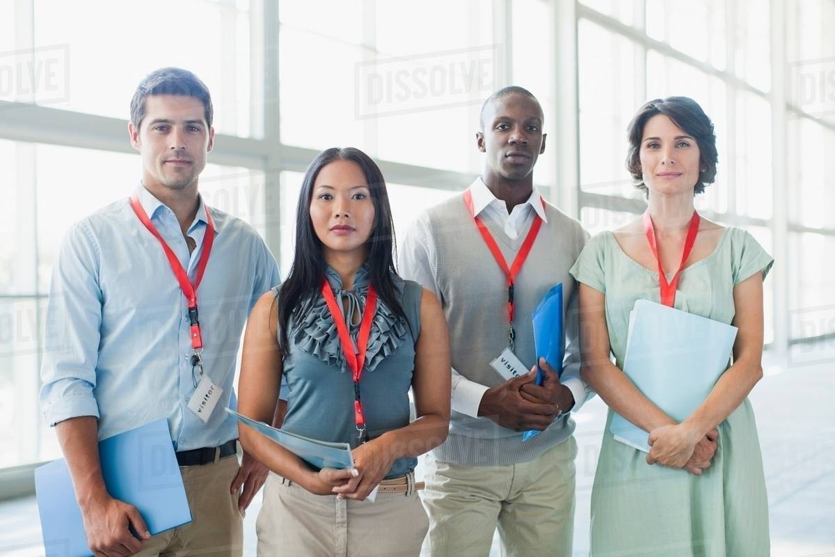 Business people wearing name tags Stock Photo Dissolve