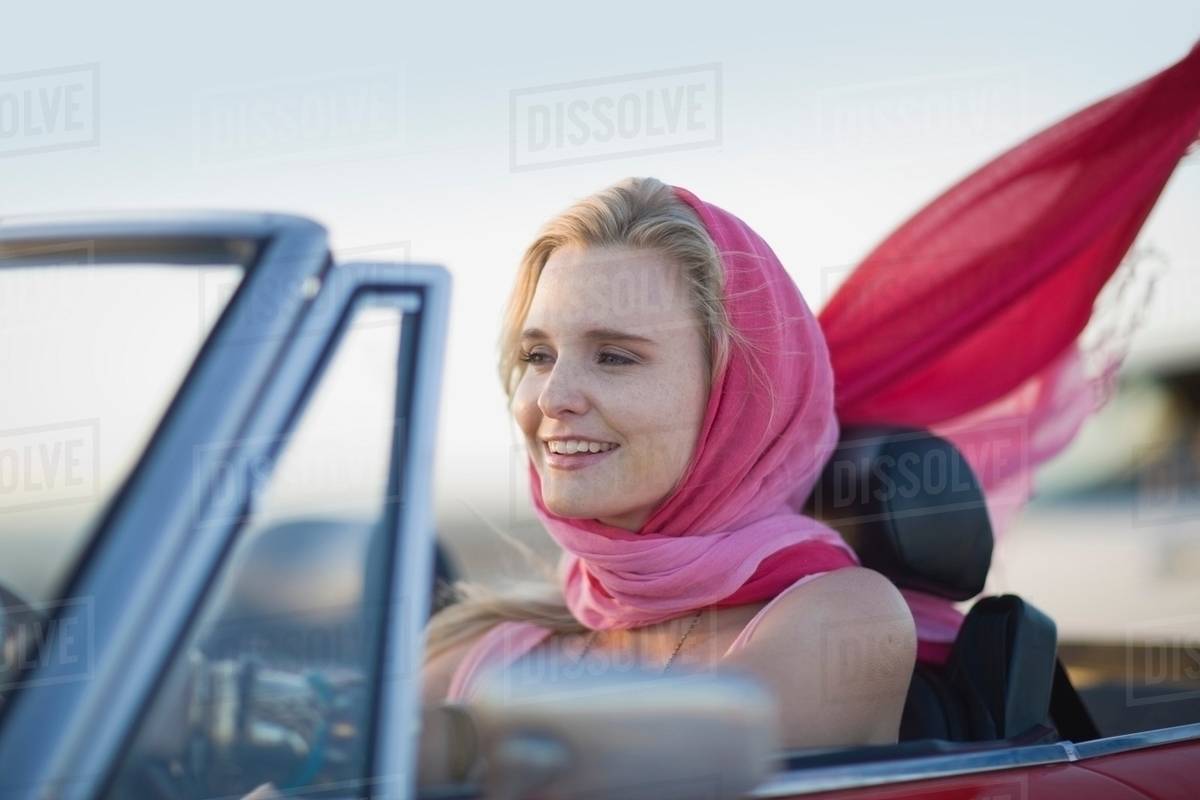 Woman driving a convertible car Stock Photo Dissolve
