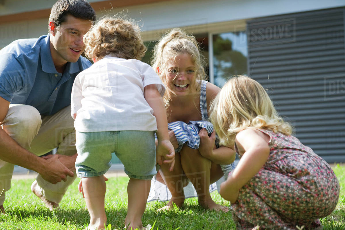 Family playing together outdoors - Stock Photo - Dissolve