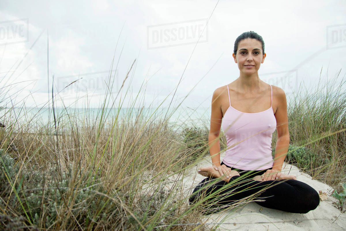 Mature woman sitting in lotus position