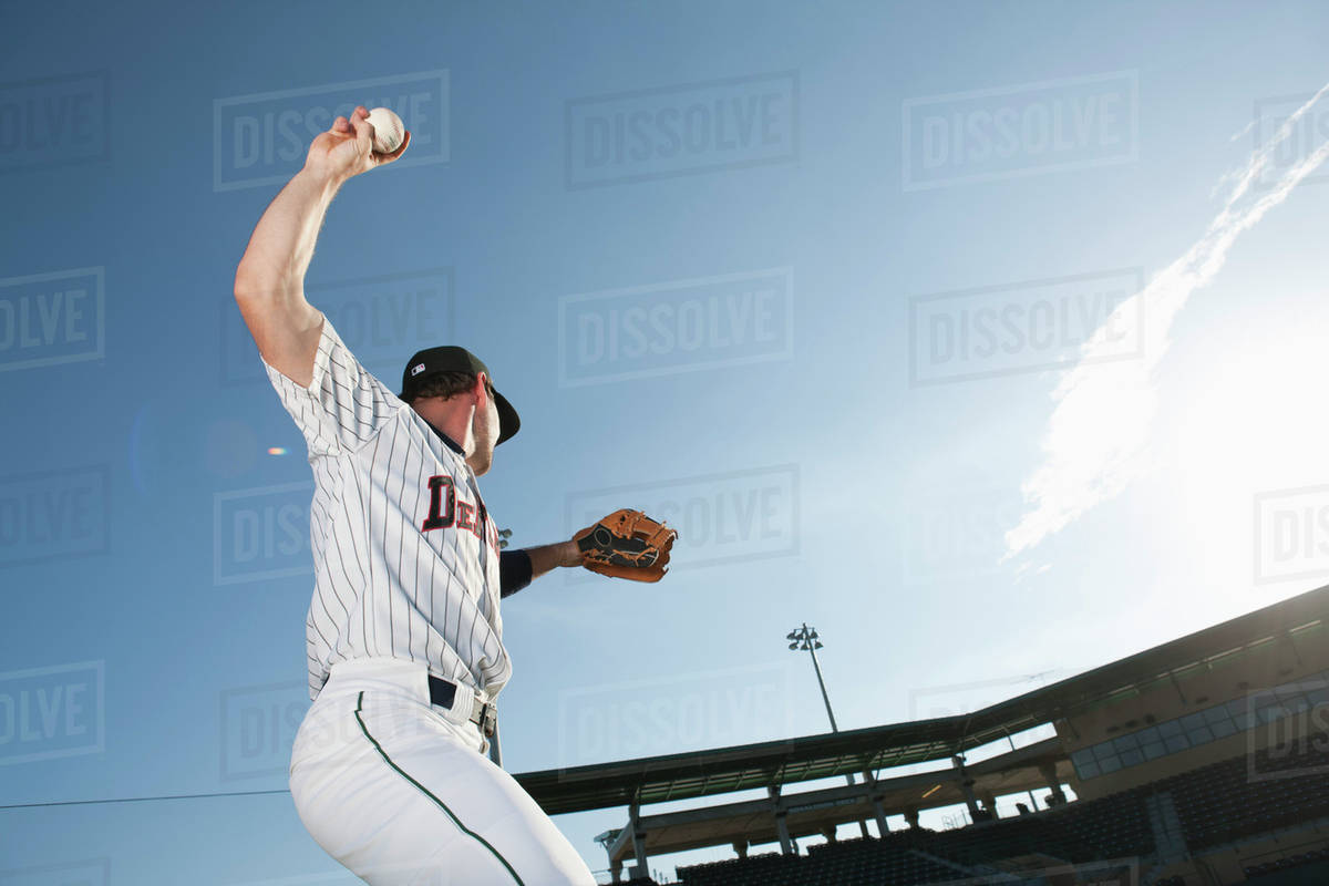 Baseball player throwing ball Stock Photo Dissolve