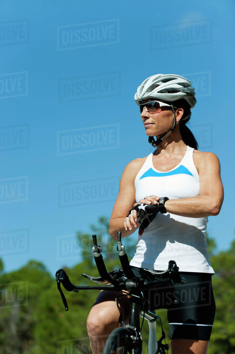 Female cyclist taking break Stock Photo Dissolve