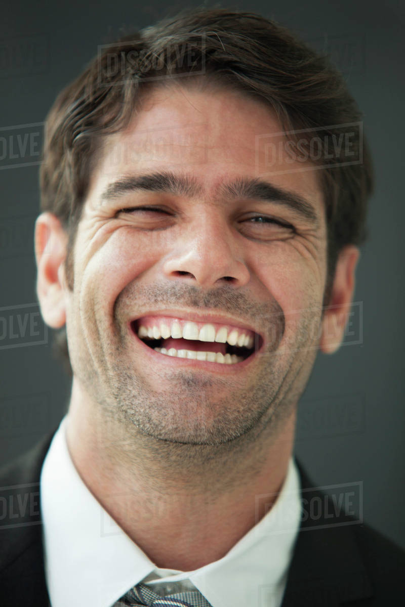 Man bursting out laughing, portrait Stock Photo Dissolve