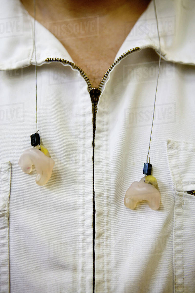 Machinist wearing earplugs around neck Stock Photo Dissolve