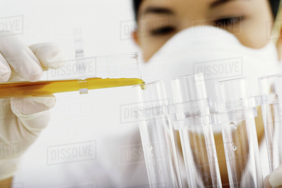 Laboratory technician transferring liquid to test tube Stock Photo