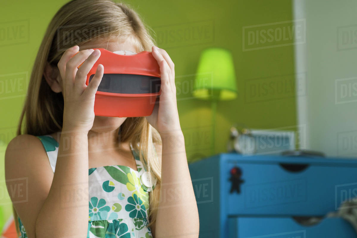 Girl looking through toy viewfinder Stock Photo Dissolve