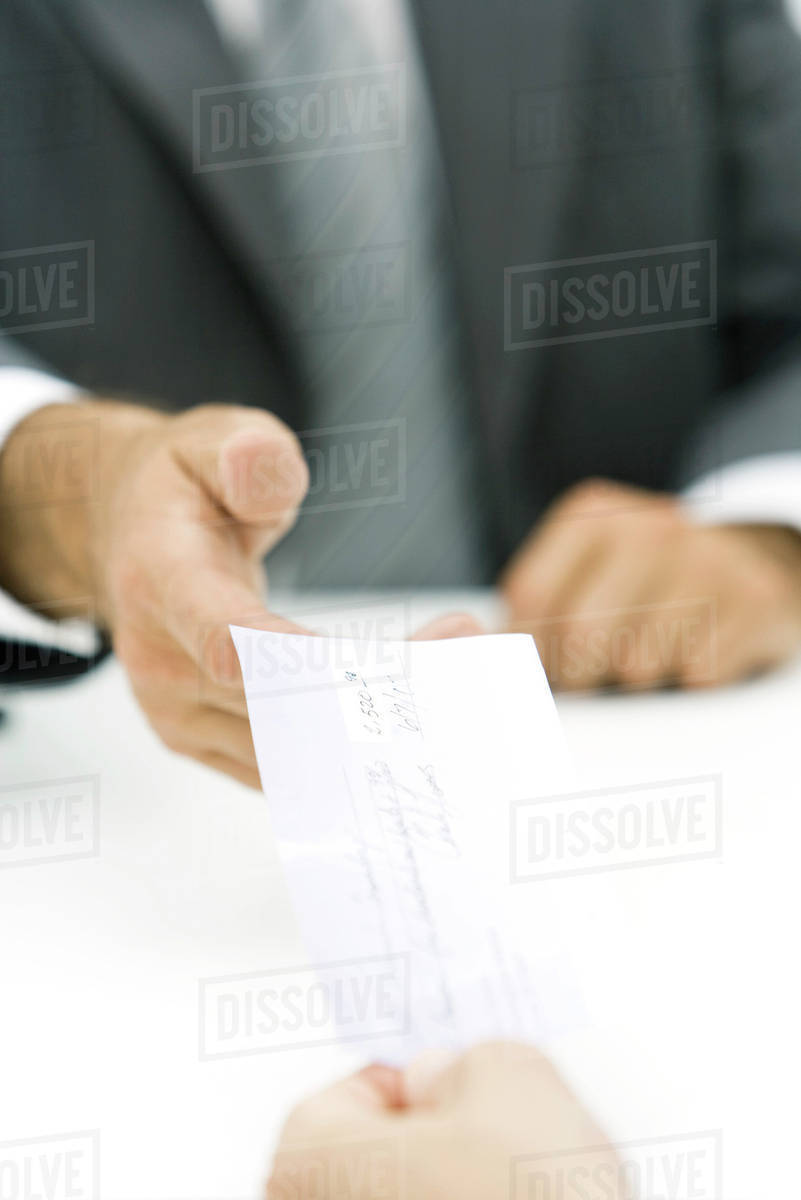 Businessman accepting check, cropped view of hands Stock Photo Dissolve