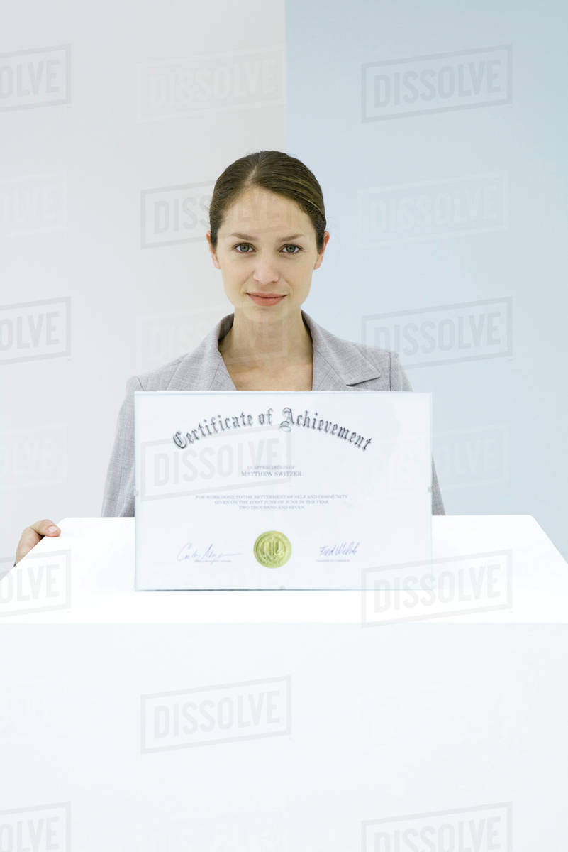 Woman displaying certificate of achievement Stock Photo Dissolve
