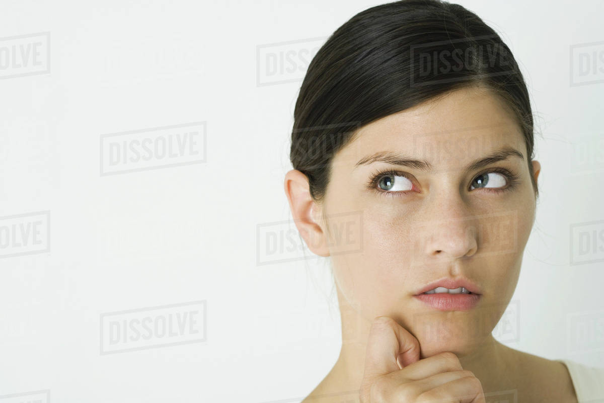 Woman looking up, hand under chin, close-up - Royalty-free Stock Photo ...