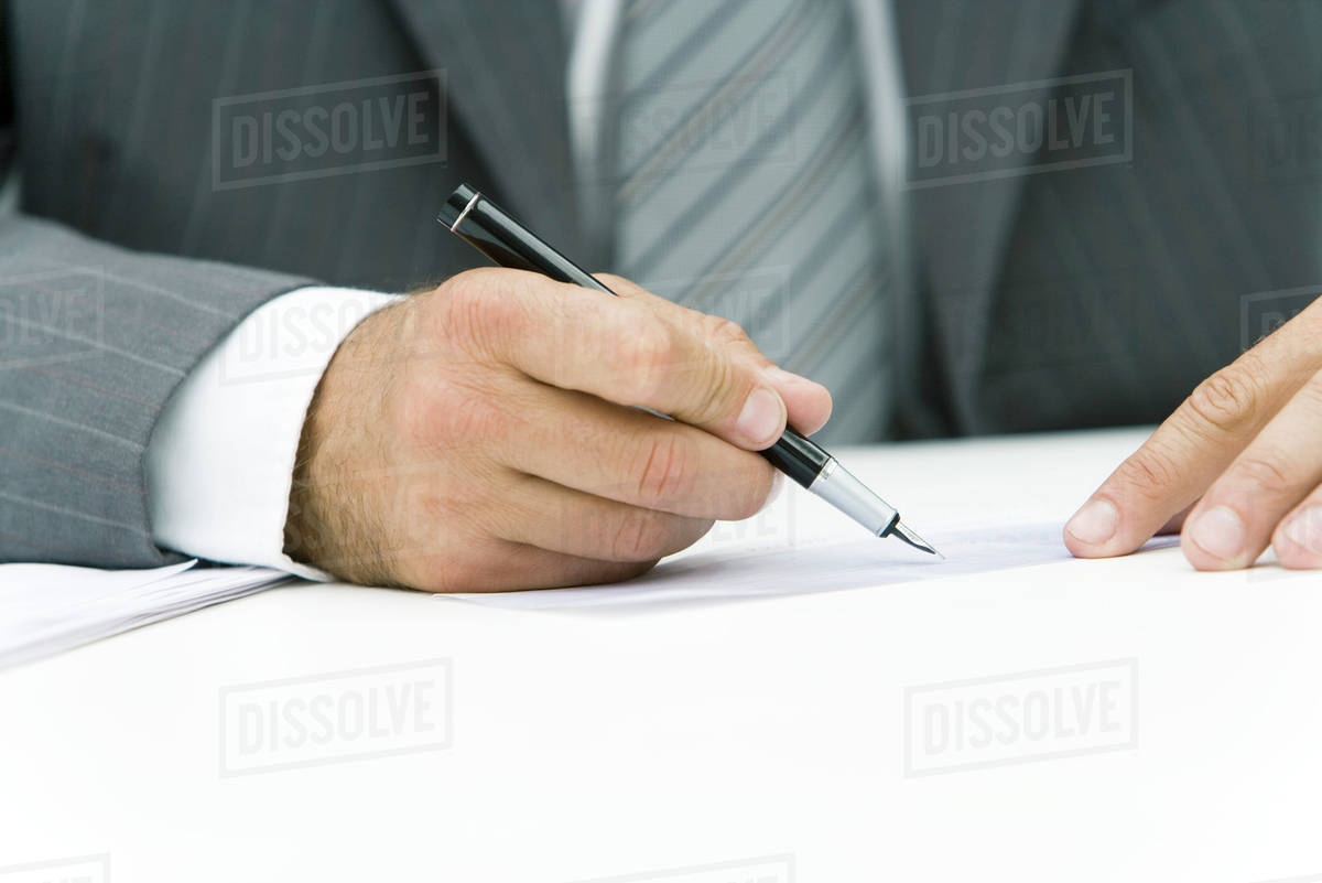 businessman signing check cropped view of hands d984_29_611 signing a check