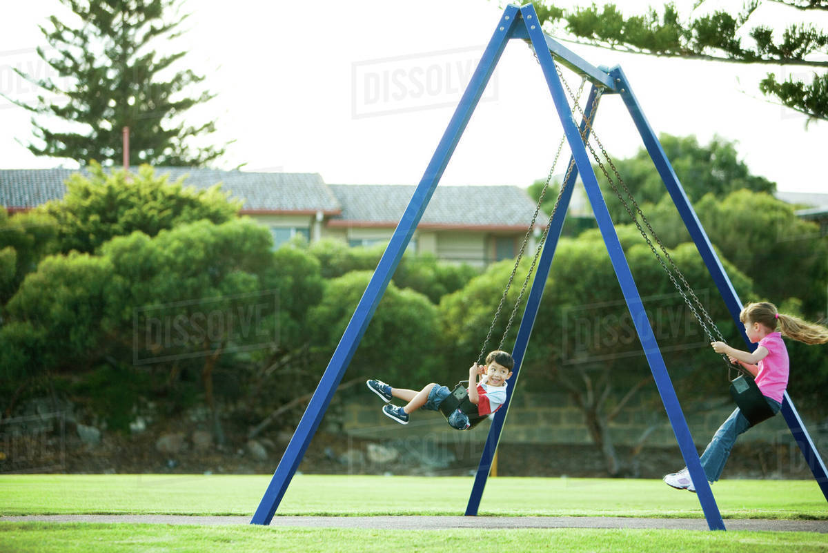 children on swings stock