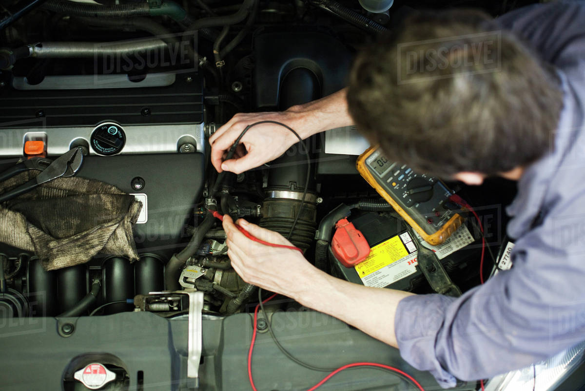Mechanic diagnosing car engine problem Stock Photo Dissolve