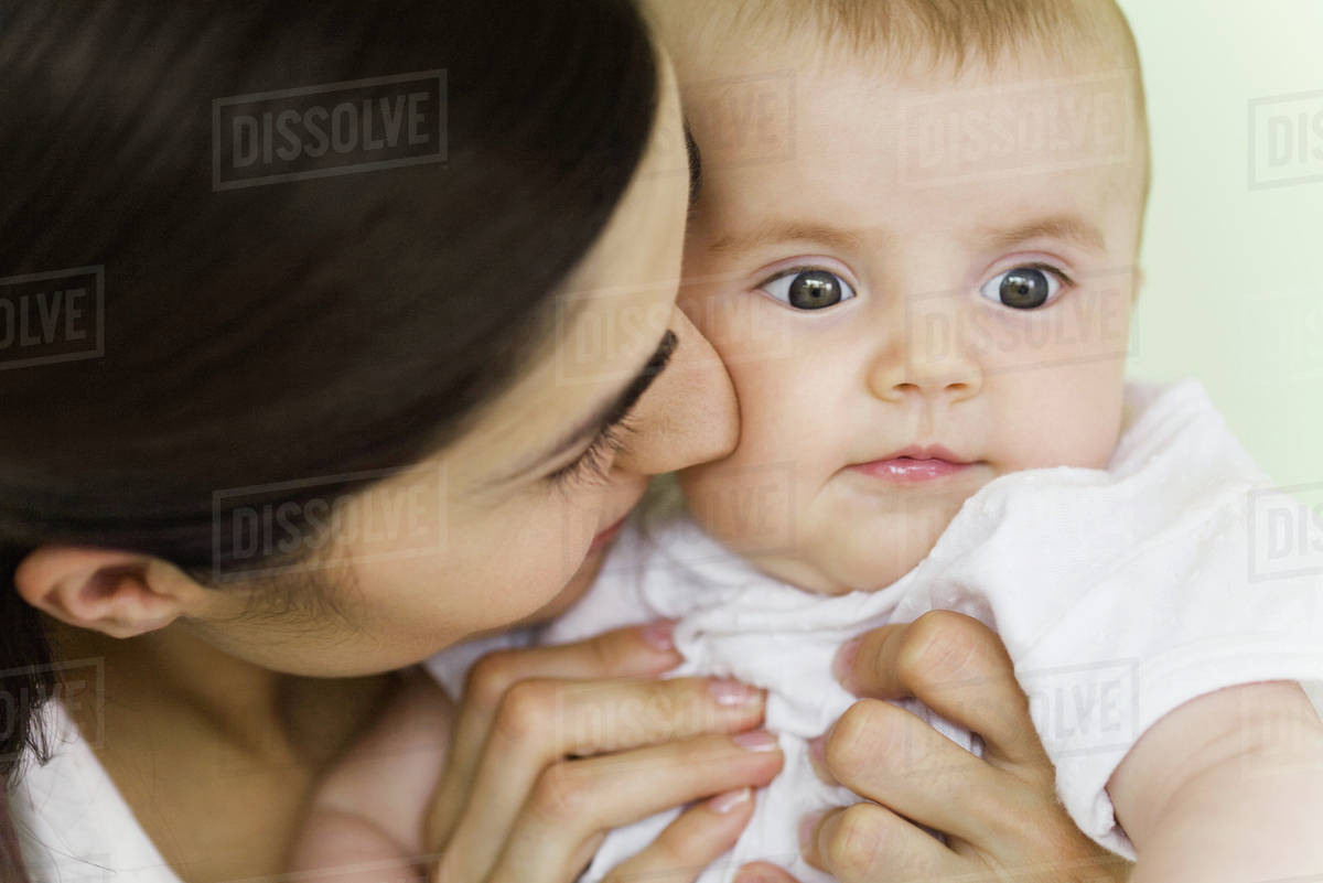 Woman nuzzling baby, closeup Stock Photo Dissolve