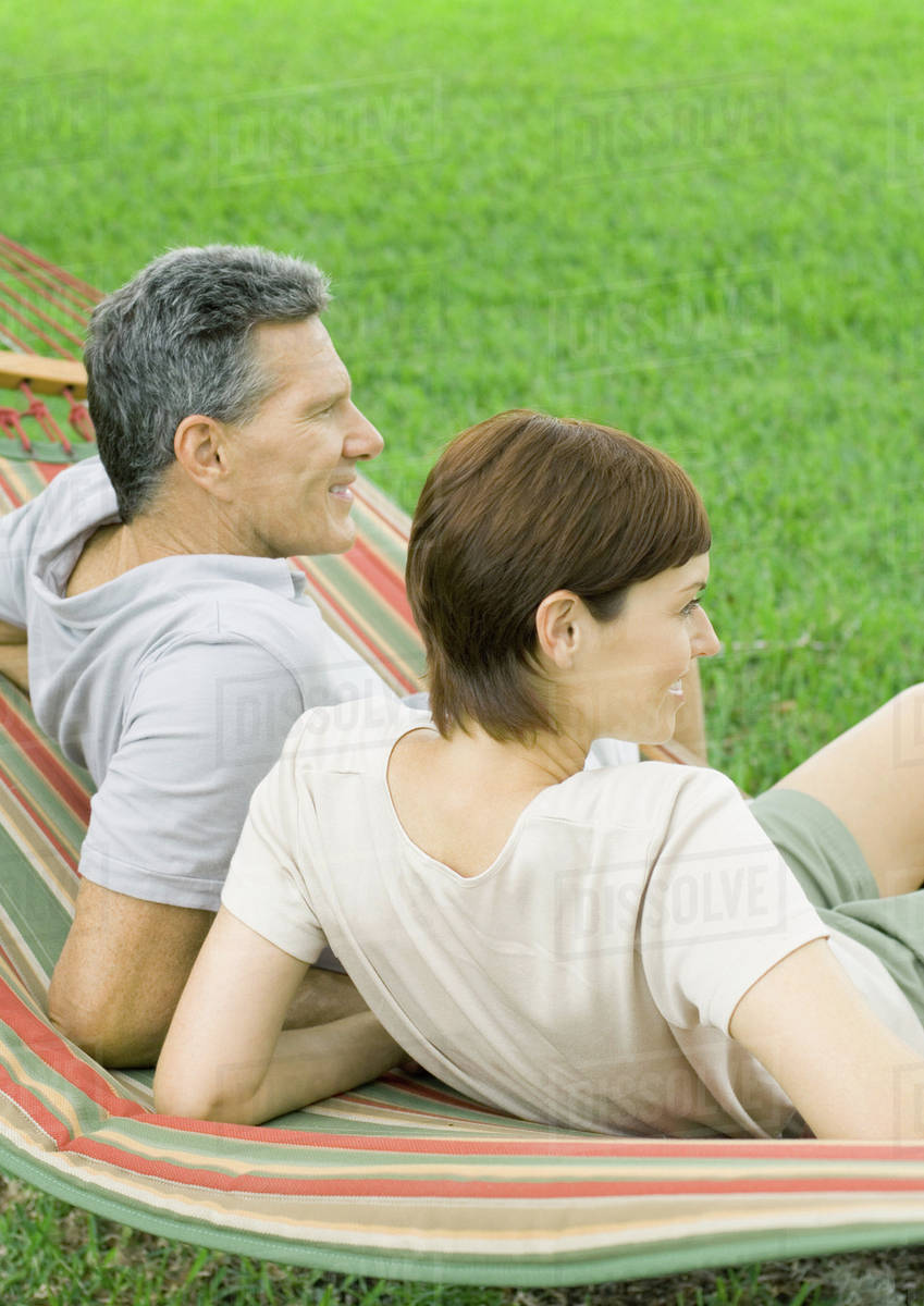 Couple lounging in hammock Stock Photo Dissolve