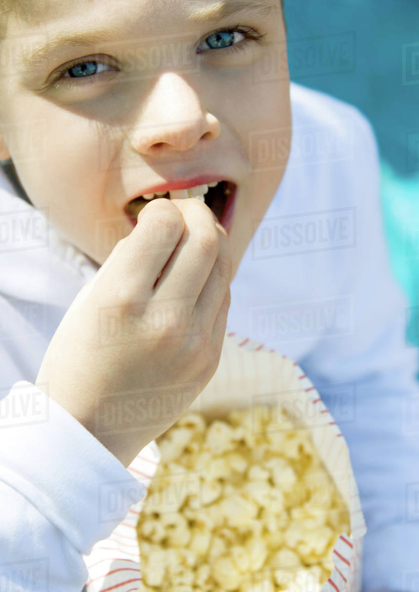 Child eating popcorn Stock Photo Dissolve
