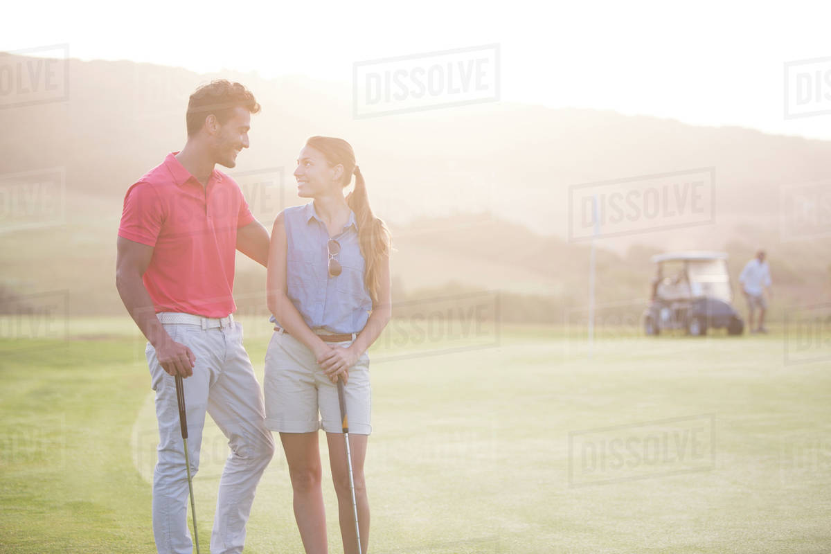 Couple on golf course Stock Photo Dissolve