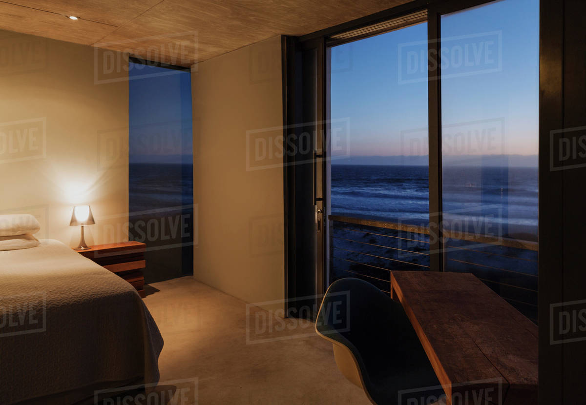 Modern bedroom overlooking ocean at dusk Stock Photo Dissolve