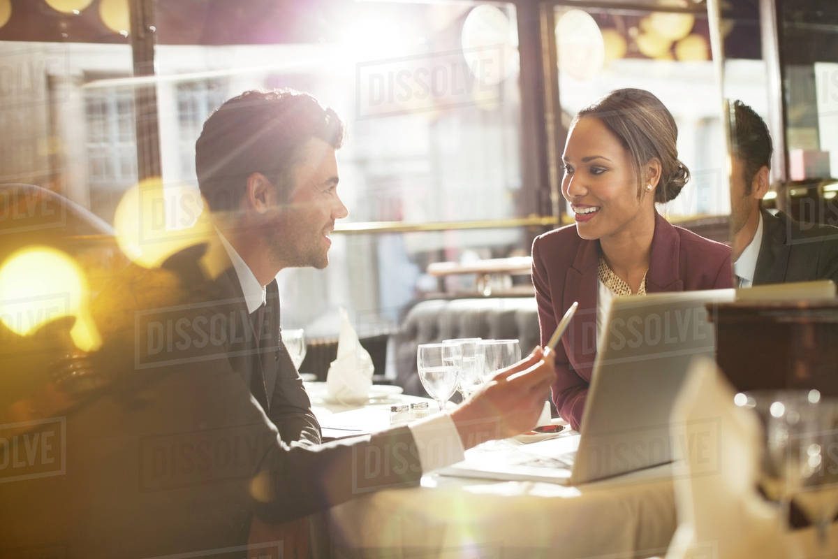 Business people talking in restaurant Stock Photo Dissolve