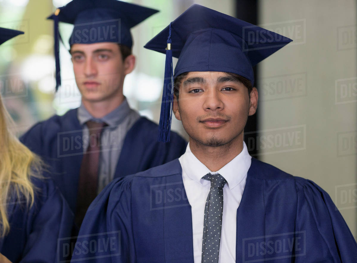 Male student in graduation clothes looking at camera Royalty