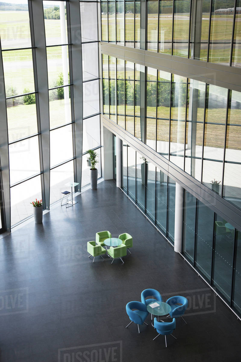 Chairs and table in office lobby area Stock Photo Dissolve