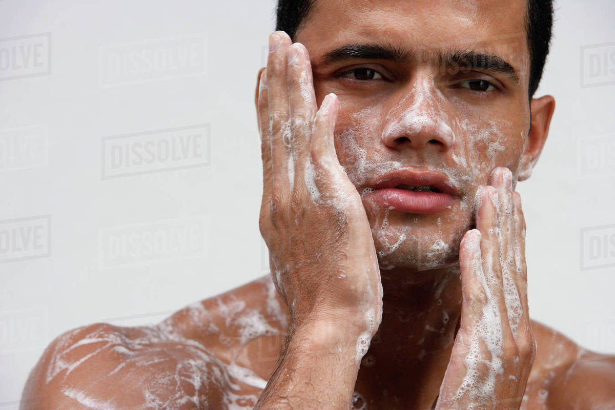 Man covering in soap suds Stock Photo Dissolve