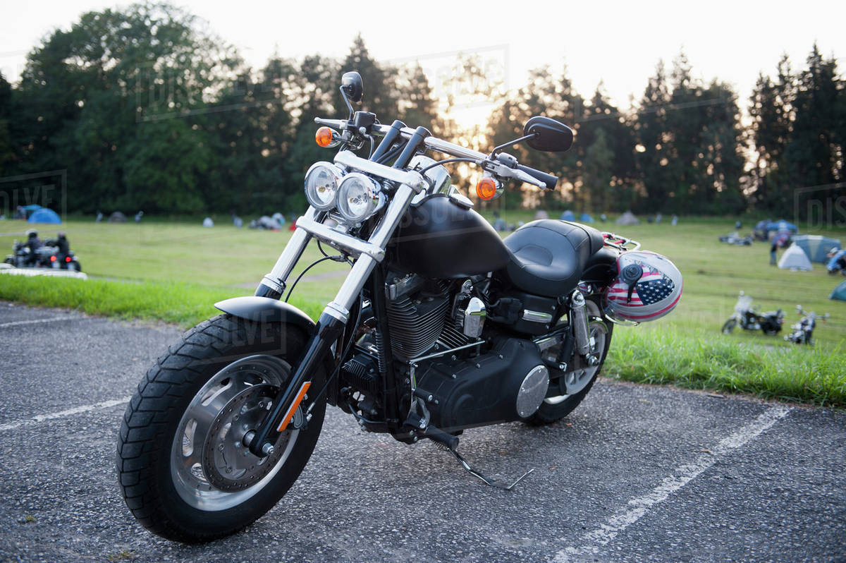 A motorcycle parked in a parking space at a park Stock Photo Dissolve