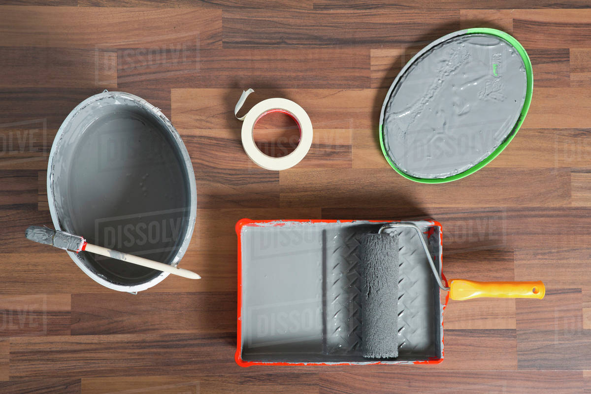 House painting equipment on a hardwood floor Stock Photo Dissolve