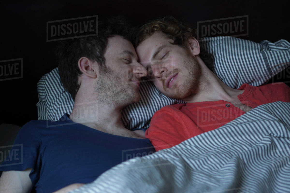 Relaxed young gay couple sleeping in bed Royalty-free stock photo