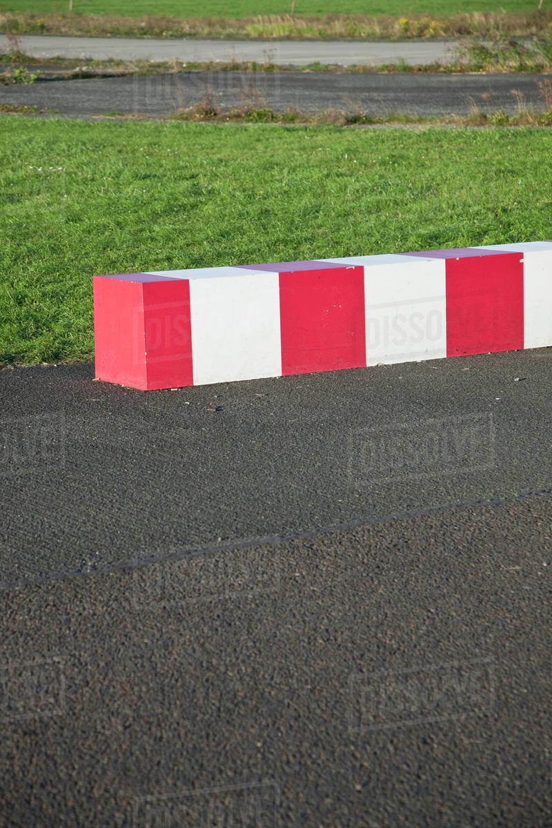 Striped concrete barrier in a parking lot - Royalty-free Stock Photo ...