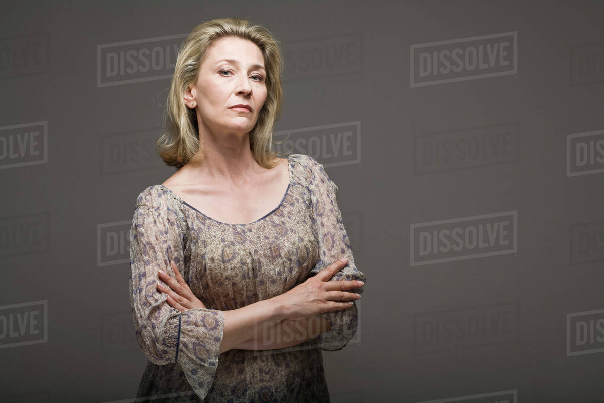 Stern woman with arms crossed - Stock Photo - Dissolve