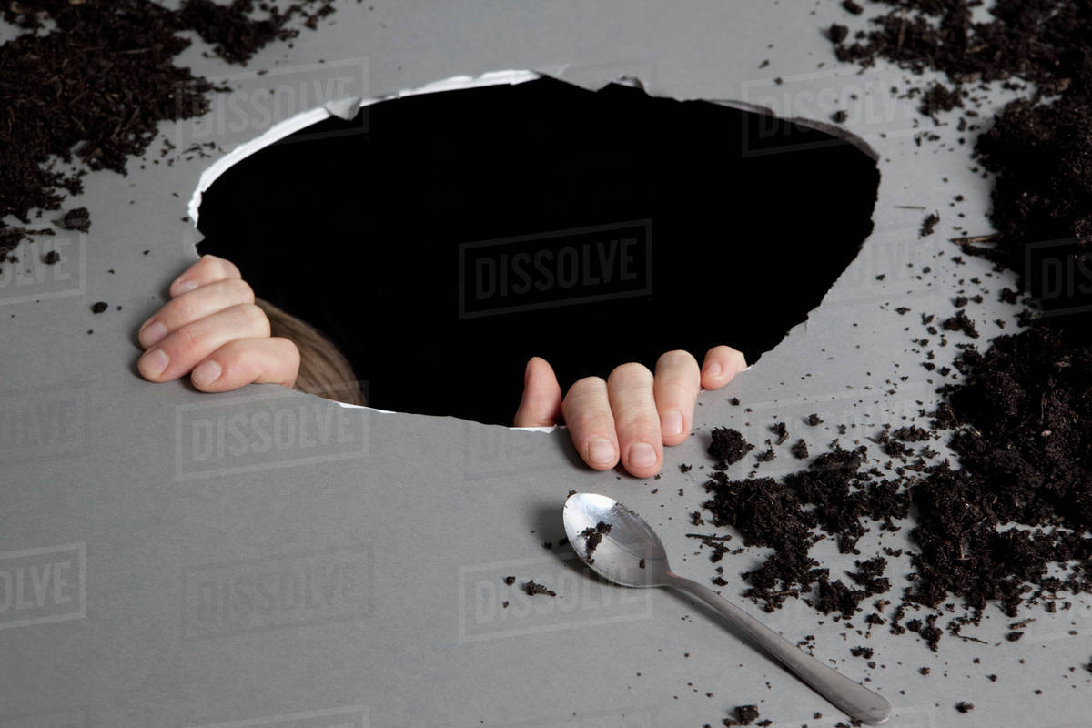 Detail of a person in a hole Stock Photo Dissolve