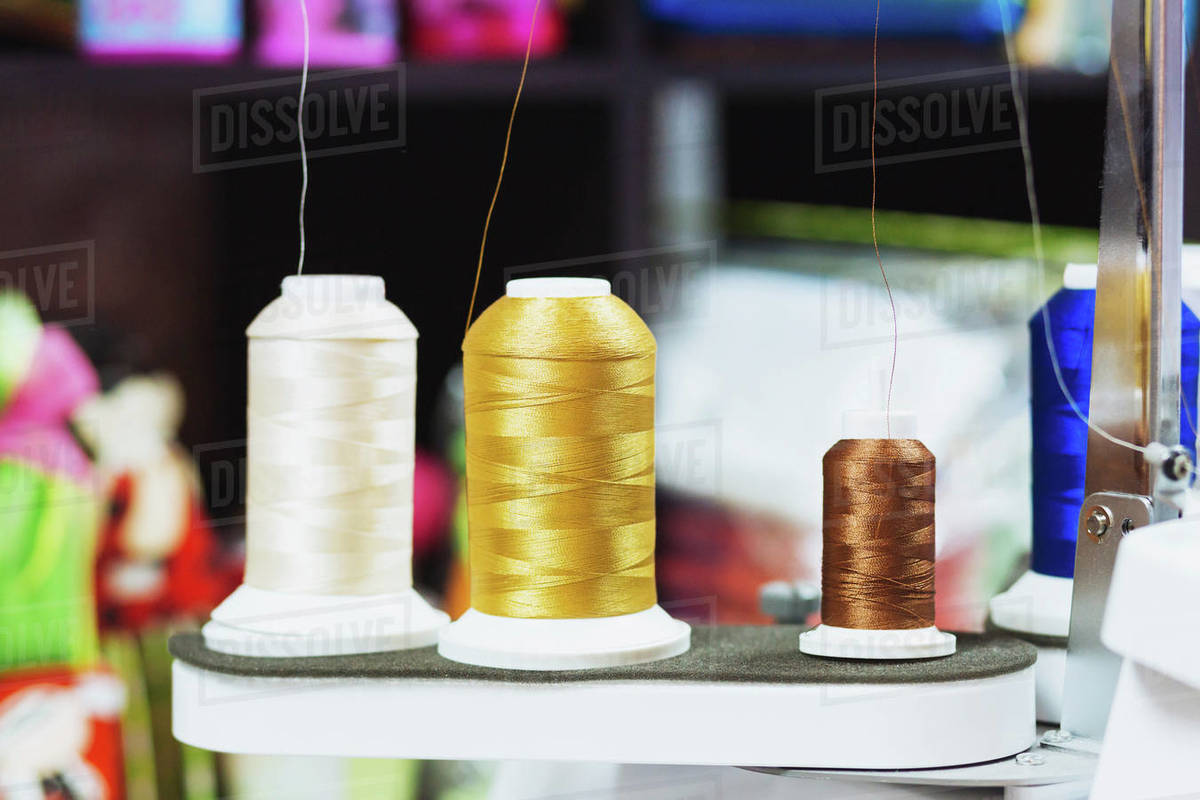 Closeup of various spools on sewing machine Stock Photo Dissolve