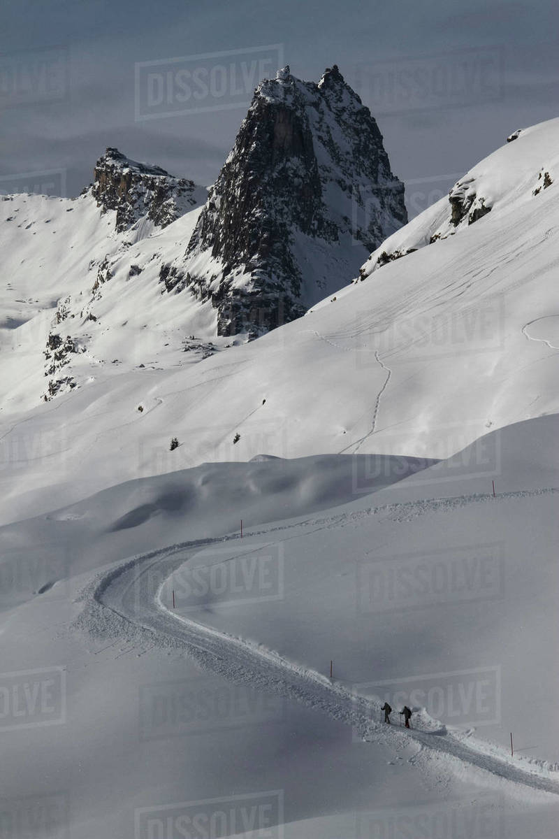 Snowshoers on sunny, snowy mountain slope, Vals, Canton of Grisons, Switzerland Royalty-free stock photo