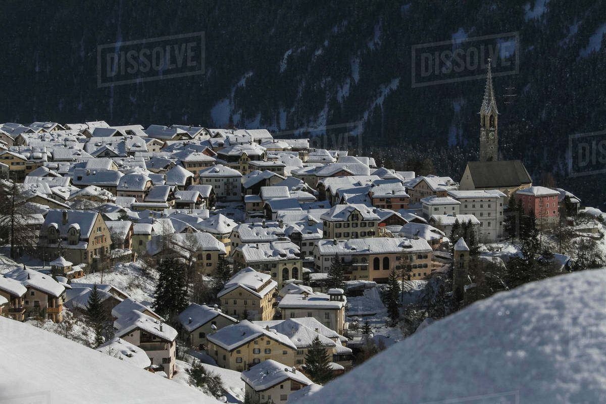 Scenic view sunny snow covered village rooftops, Sent, Canton of Grisons, Switzerland Royalty-free stock photo