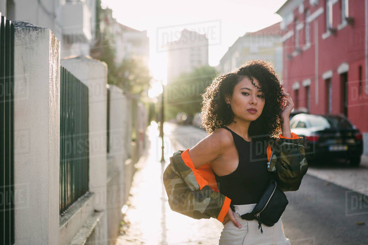 Portrait confident, stylish young woman on sunny city street Royalty-free stock photo