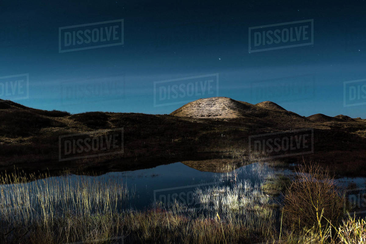 Tranquil illuminated dunes at night, Norddorf, Schleswig Holstein, Germany Royalty-free stock photo