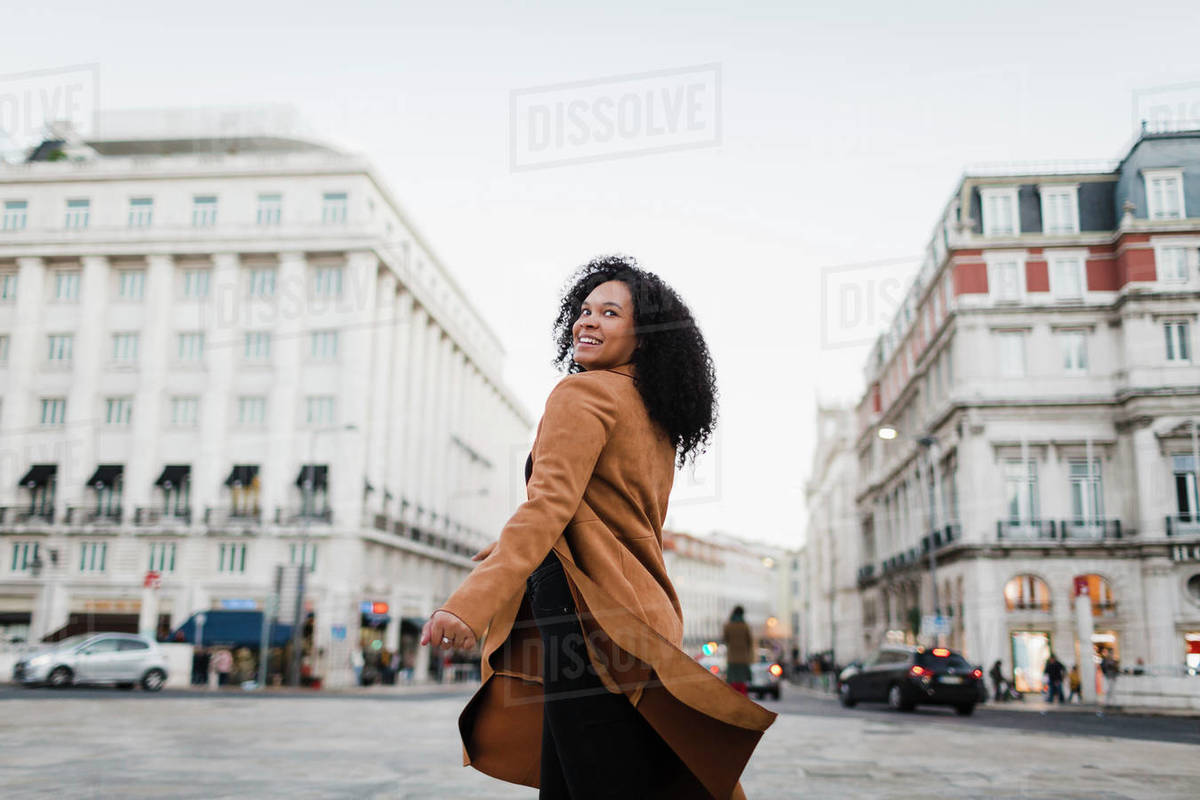 Portrait carefree young woman on urban street, Lisbon, Portugal Royalty-free stock photo